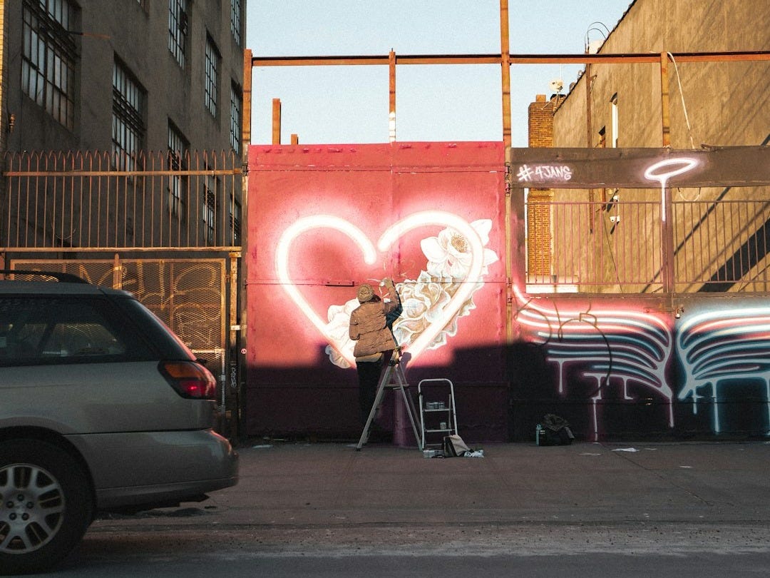 man drawing wall graffiti