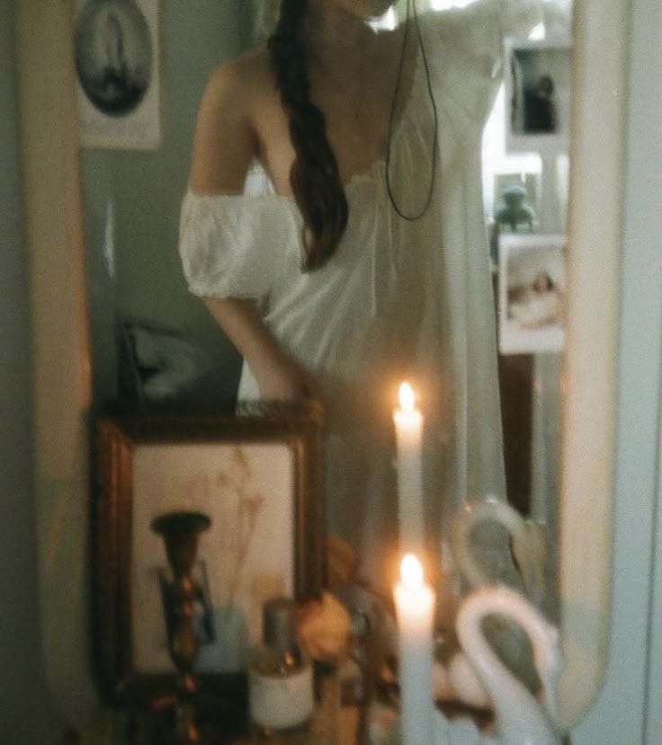This may contain: a woman standing in front of a mirror wearing headphones