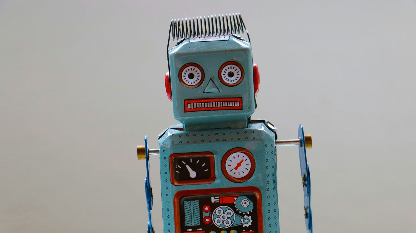 An old, tilting robot toy with a blue metal body and colorful gears.