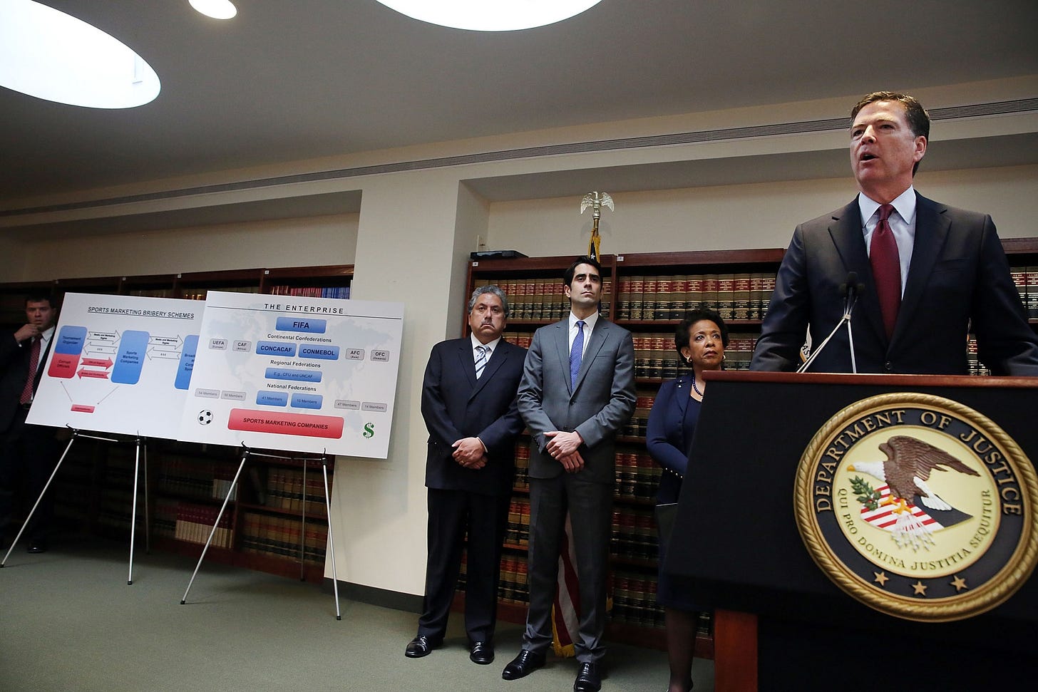 FBI Director James Comey discusses the indictment during a press conference at the DOJ.