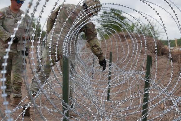 Texas troops install concertina wire along Rio Grande Texas troops install concertina wire along Rio Grande
