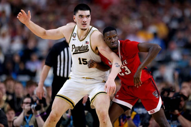 Zach Edey of the Purdue Boilermakers calls for the ball while defended by Mohamed Diarra of the NC State Wolfpack during the second half in the NCAA...