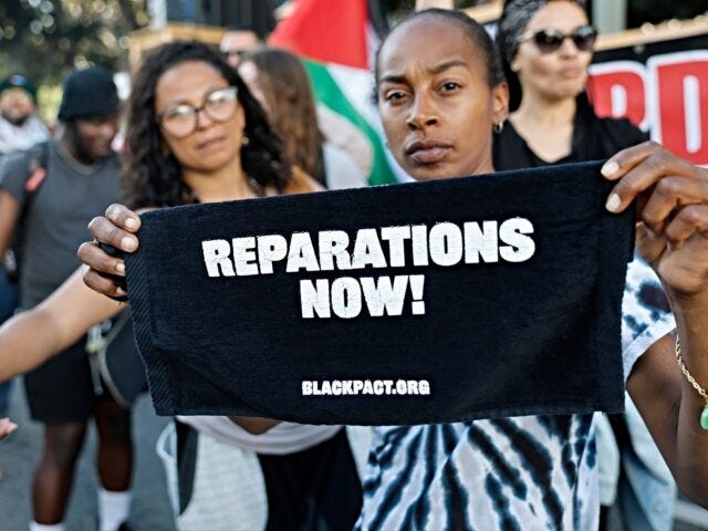 LOS ANGELES, CALIFORNIA - MAY 21: A protestor displays sign reading "Reparations Now!" dur