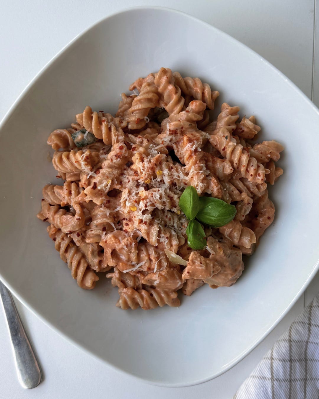 Macro-friendly pasta dish made with Skyr, zucchini, and chickpea pasta in a creamy tomato sauce