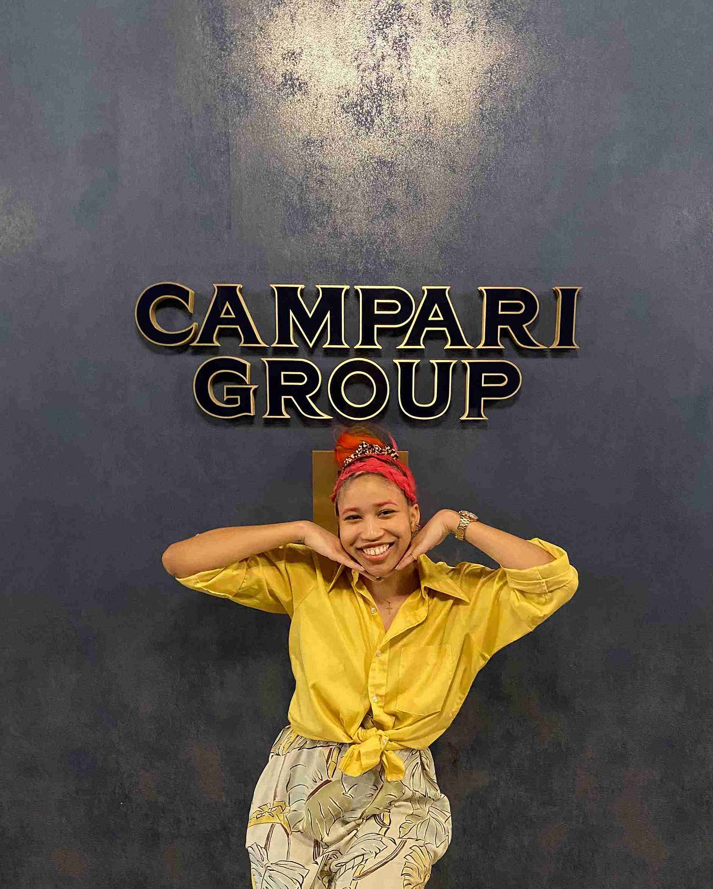 Kiana posing in front of the Campari Group sign at the Campari America Headquarters