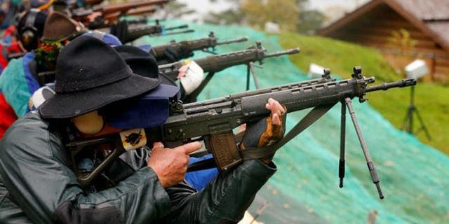 Participants fire their infantry and assault rifles during the traditional 'Ruetlischiessen' (Ruetli shooting) competition in central Switzerland. (REUTERS/Arnd Wiegmann)