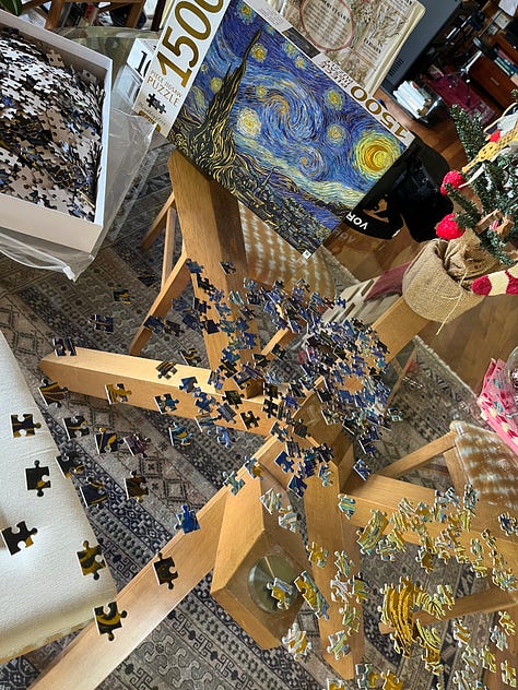 a jigsaw of the vincent van gogh painting starry starry night in various levels of completion. the final photo shows the four duplicate pieces included next to where they matched the puzzle.