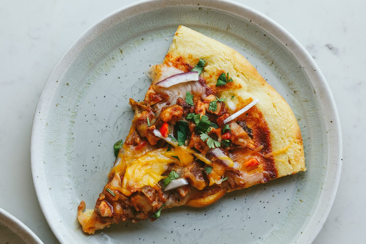 BBQ chicken and peach flatbread slice on a plate.