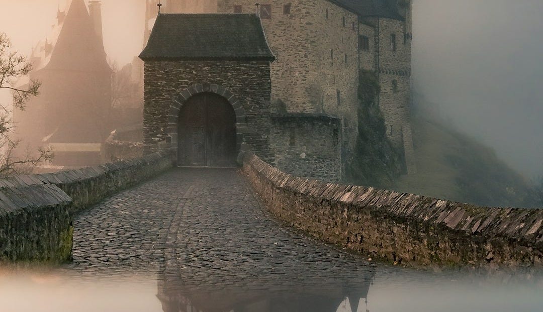 reflection of a castle surrounded with fogs