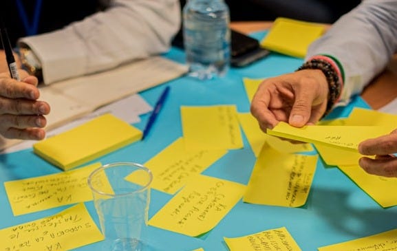 person holding yellow sticky notes