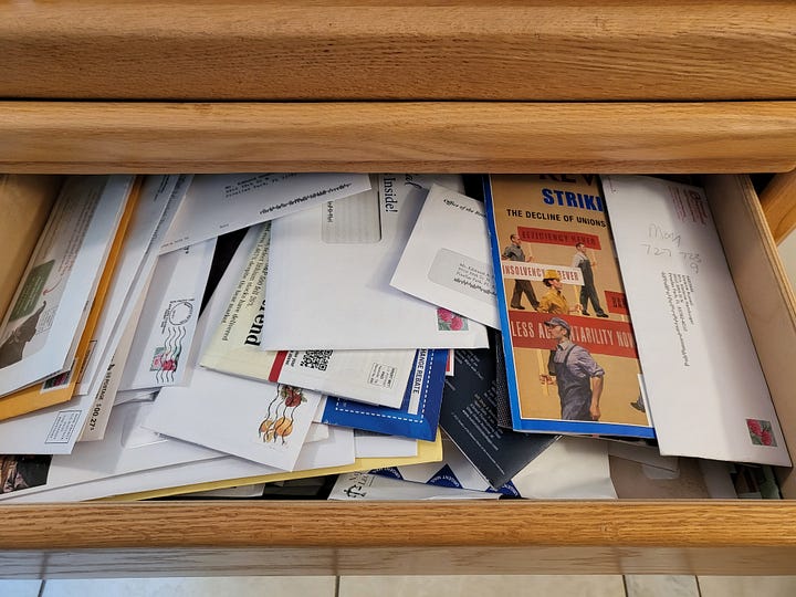 drawer with hundreds of unopened envelopes