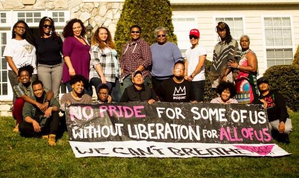 Mandy standing with a group of younger folks from SONG with a banner that reads: "No PRIDE for some of us without liberation for all of us. We can't breathe."