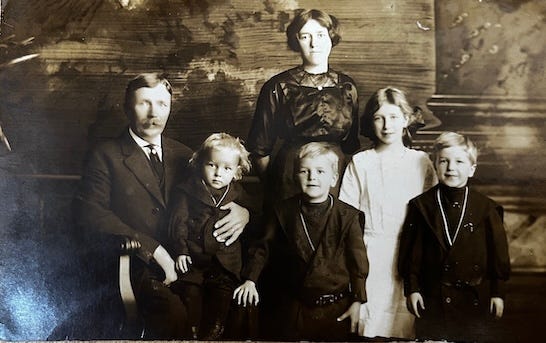 A family photo of two people and several children

AI-generated content may be incorrect.