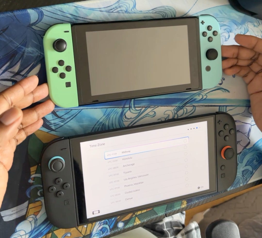 Both my Nintendo Switch 1 and 2 side by side showing the size difference.