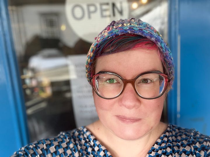 Me with pink hair, new glasses and a fabulous dress. A cozy corner of the bookstore.