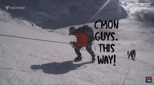 a man climbs a snowy mountain with the words " c mon guys this way " below him a man climbs a snowy mountain with the words " c mon guys this way " below him