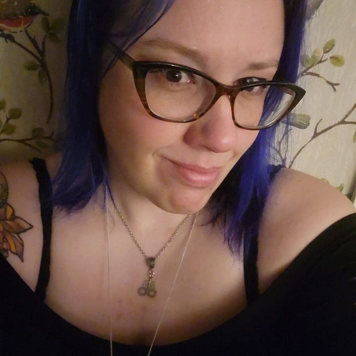 A picture of Aurora Hart and her poetry book "Forbidden"