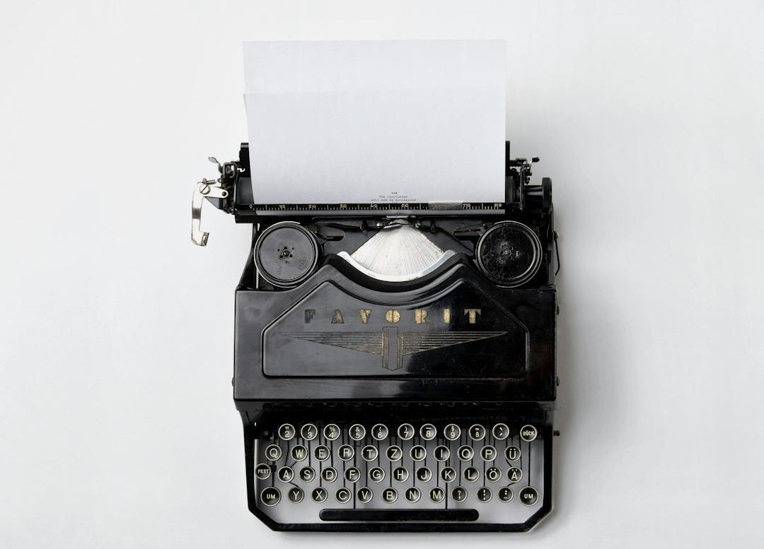 black Fayorit typewriter with printer paper