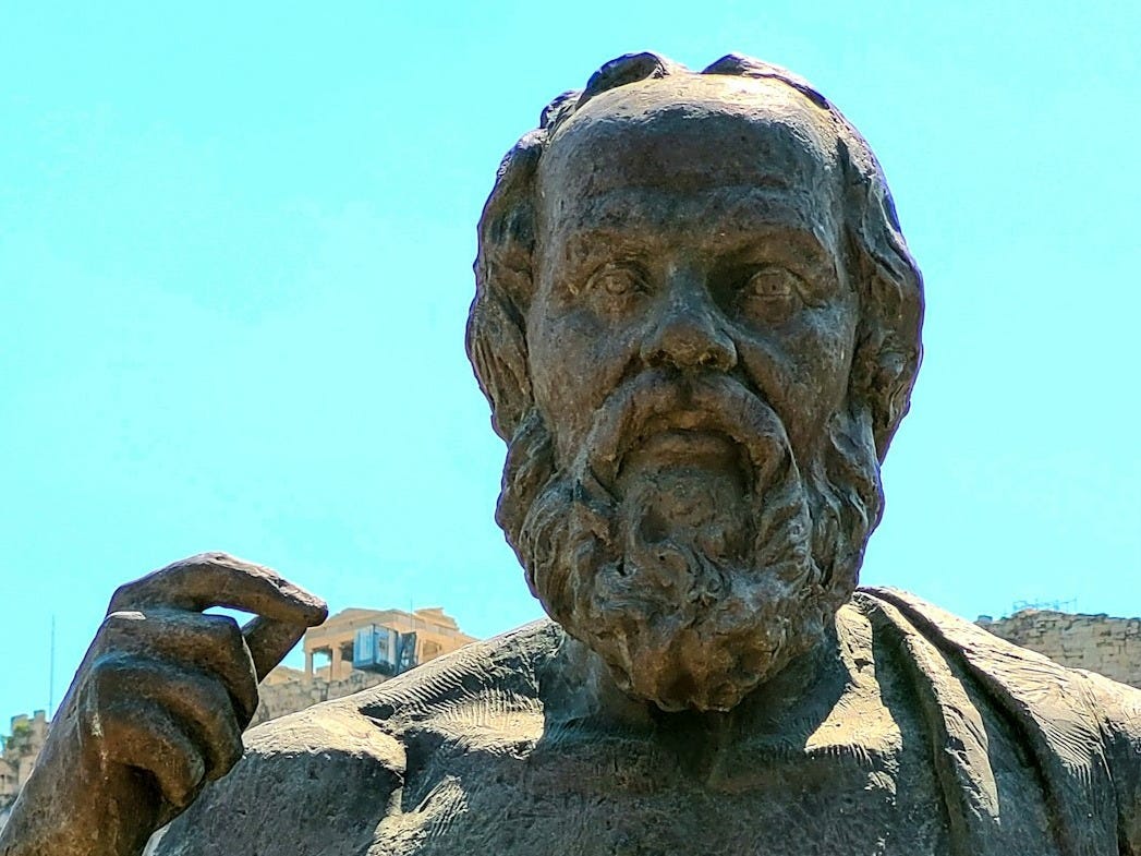 a statue of a man holding a book a statue of a man holding a book