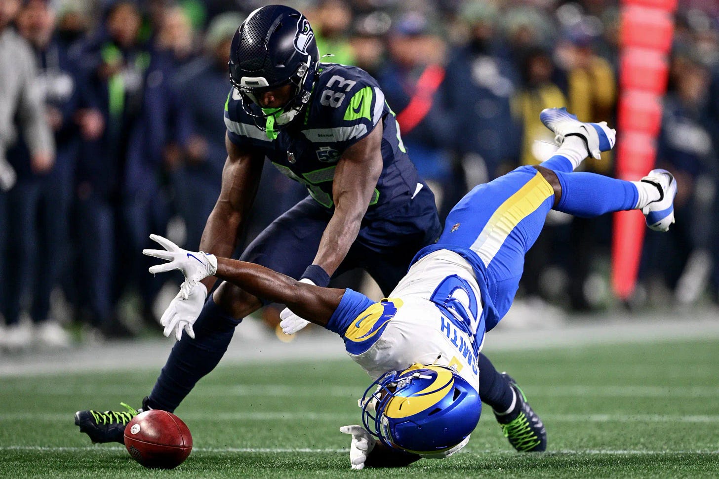 Los Angeles Rams returner Xavier Smith muffs punt as Seattle Seahawks defender recovers fumble in red zone during NFC Championship