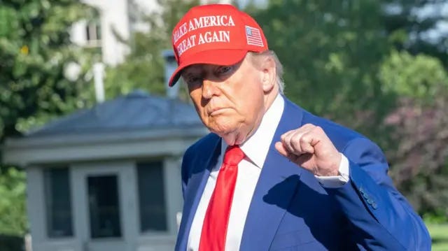 Donald J Trump gestures as he walks on the South Lawn of the White House