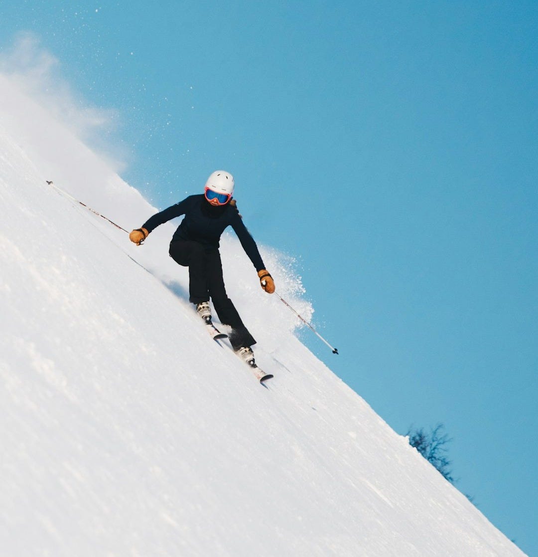 person skiing on snow with gear set person skiing on snow with gear set