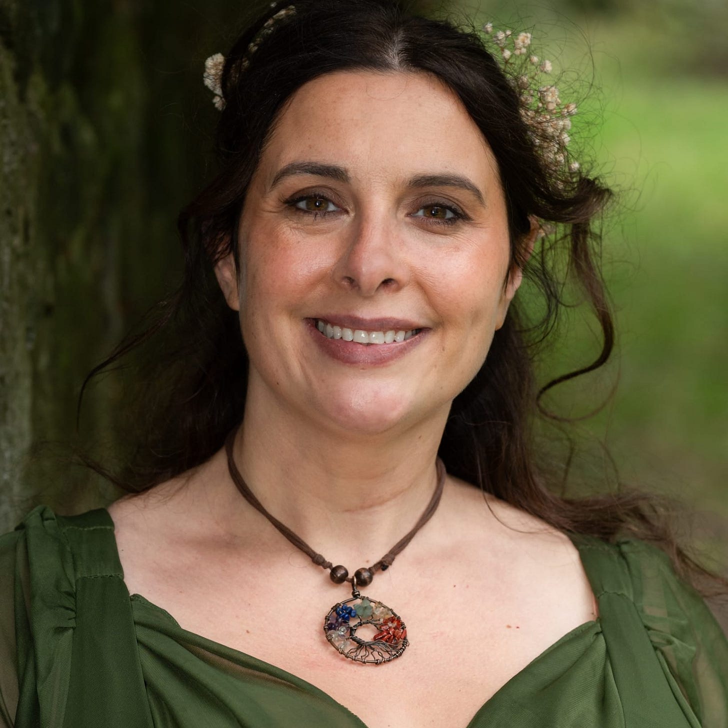 A headshot of Treasa McCabe wearing a green dress A headshot of Treasa McCabe wearing a green dress
