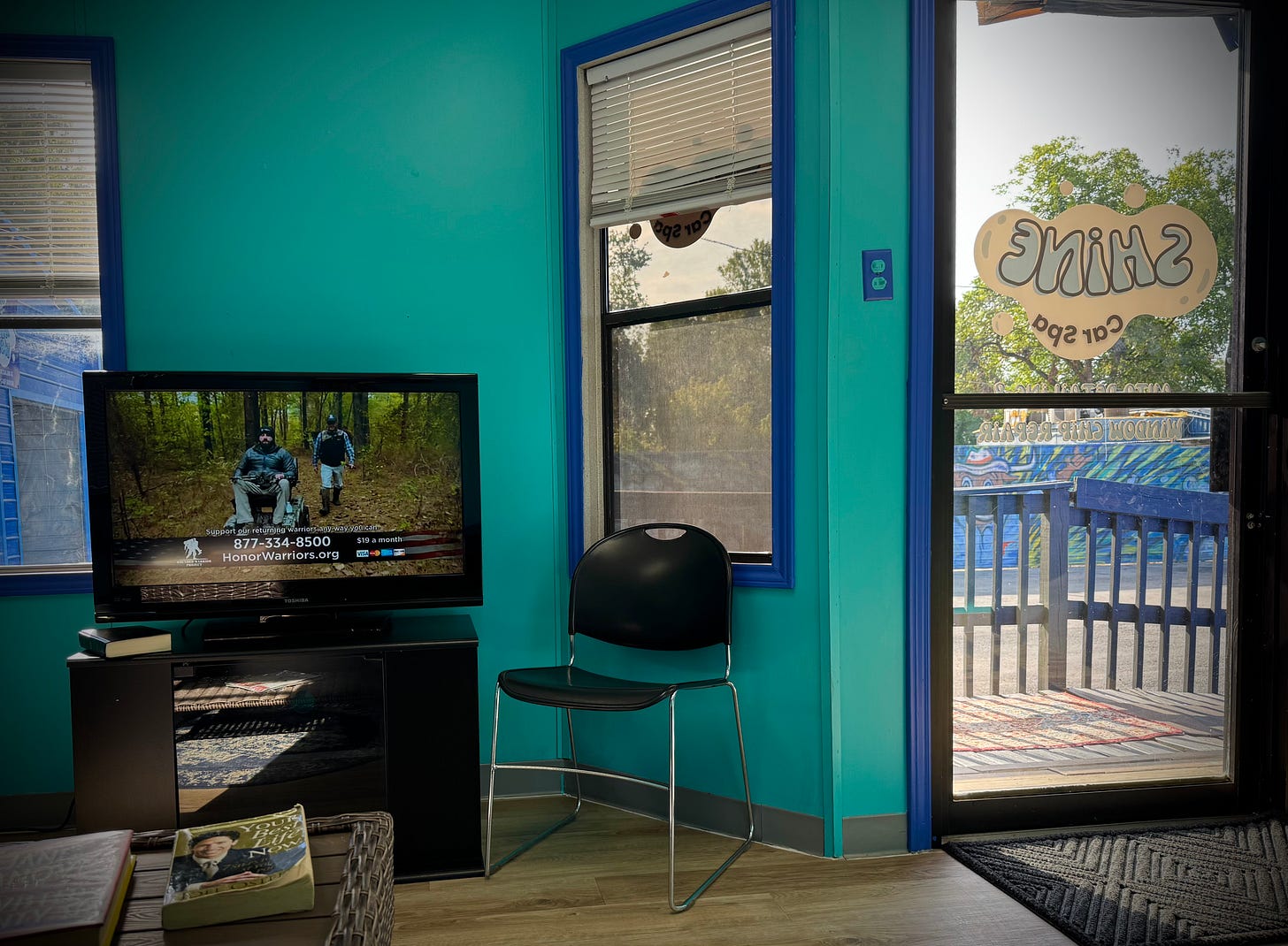 TV waiting room with glass door and Joel Osteen book