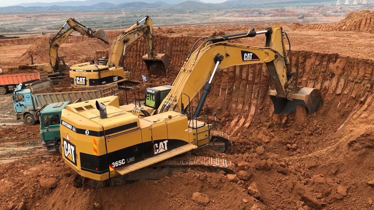 Caterpillar 365C Excavator Loading Trucks And Operator View Caterpillar 365C Excavator Loading Trucks And Operator View