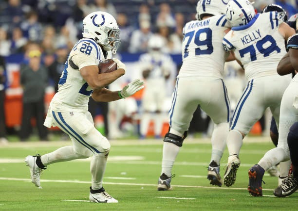 Jonathan Taylor of the Indianapolis Colts runs with the ball against the Tennessee Titans during the fourth quarter at Lucas Oil Stadium on December...