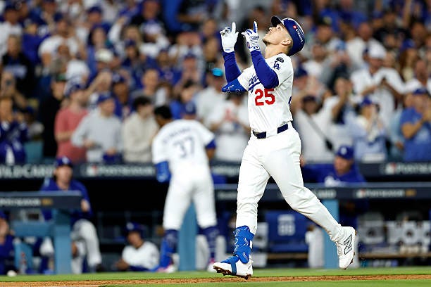 Tommy Edman of the Los Angeles Dodgers reacts after hitting a solo home run against the Cincinnati Reds during the third inning in game one of the... Tommy Edman of the Los Angeles Dodgers reacts after hitting a solo home run against the Cincinnati Reds during the third inning in game one of the...