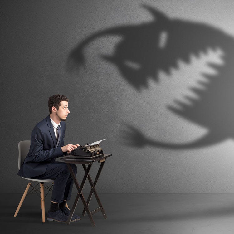 Writer facing writing fears in the form of a scary monster shadow.