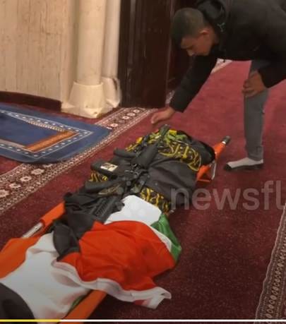 An M-16 placed on Sadil’s body