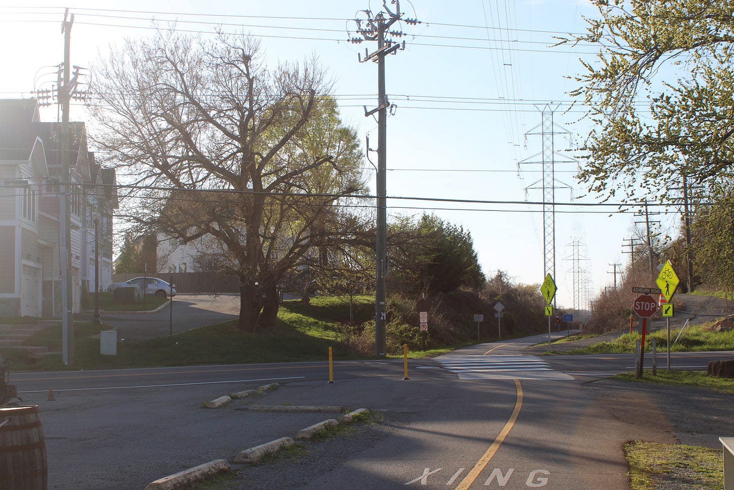 Transmission lines stand above a multi-use path adjacent to homes in Loudoun County. Credit: Charles Paullin/Inside Climate News