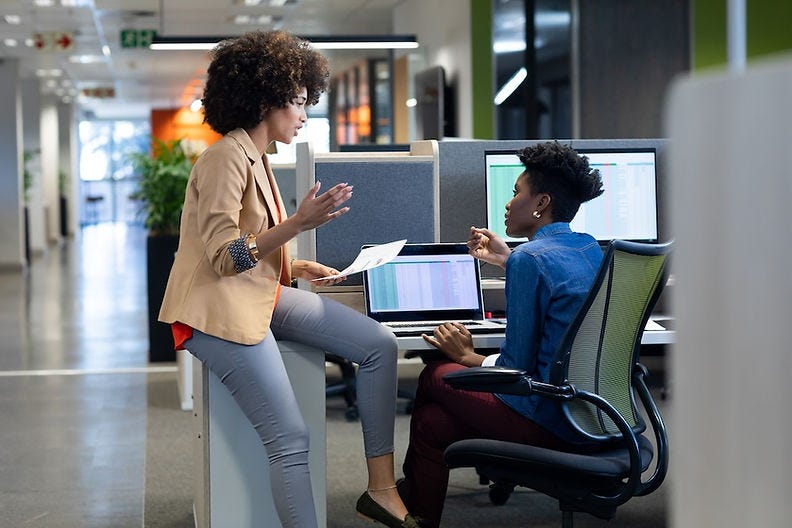 Two women agreeing to file together against workplace discrimination