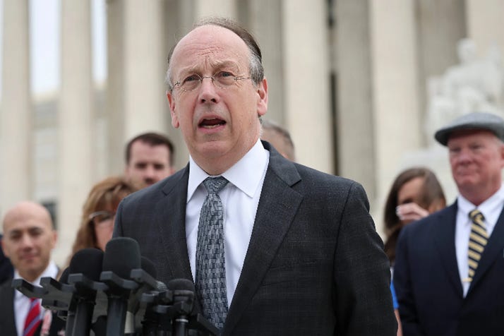 The image shows a group of people, possibly reporters, gathered in front of a building, likely the Supreme Court, with the Capitol building in the background.
AI-generated content may be incorrect.