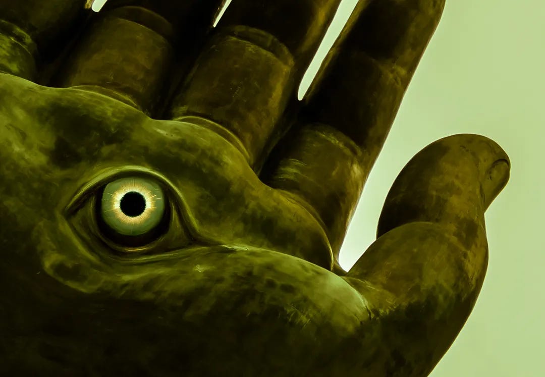 Image of a giant hand with an eye in the palm