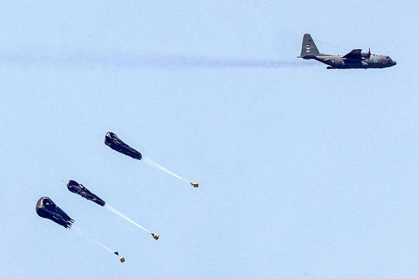 This picture taken from Israel's southern border with the Gaza Strip shows a Royal Jordanian Air Force C-130 Hercules turboprop military transport...