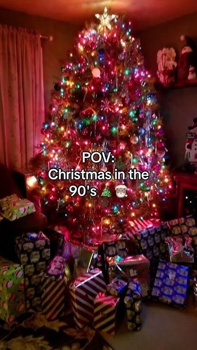 This may contain: a christmas tree with presents under it and the words pov christmas in the 90's