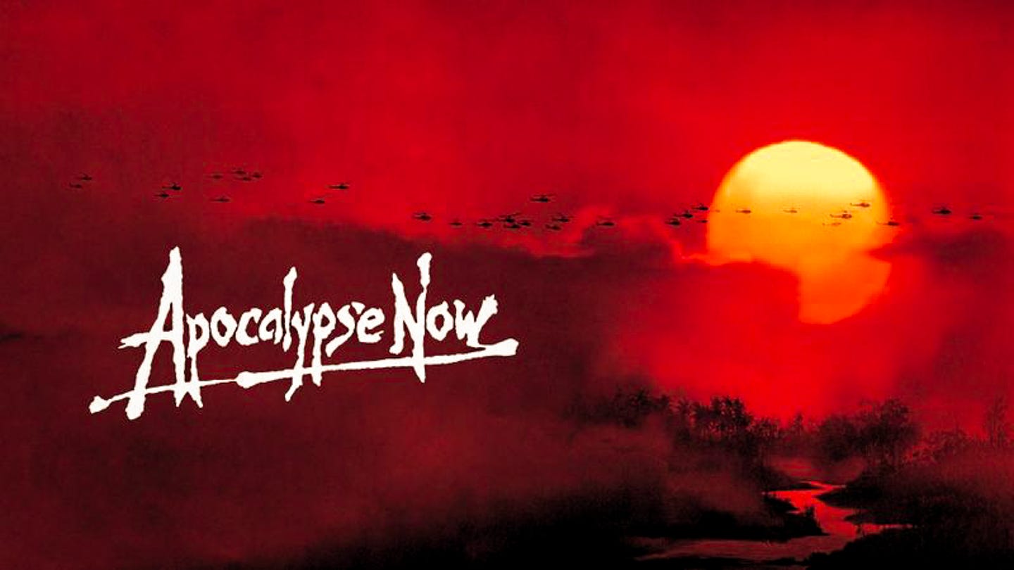 Several helicopters fly across a vivid orange dawn sky above palm trees, silhouetted against smoke and fire on the horizon. Several helicopters fly across a vivid orange dawn sky above palm trees, silhouetted against smoke and fire on the horizon.