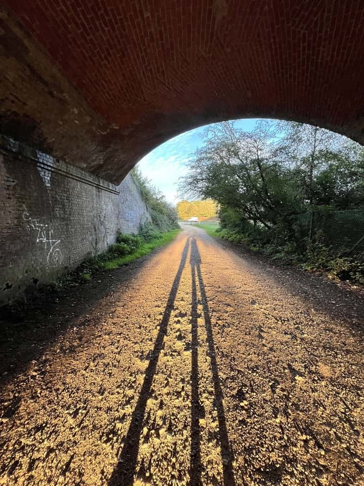 Long shadows being cast under a bridge by the evening sun Long shadows being cast under a bridge by the evening sun