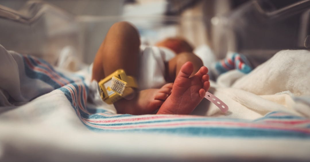 baby lying on bed