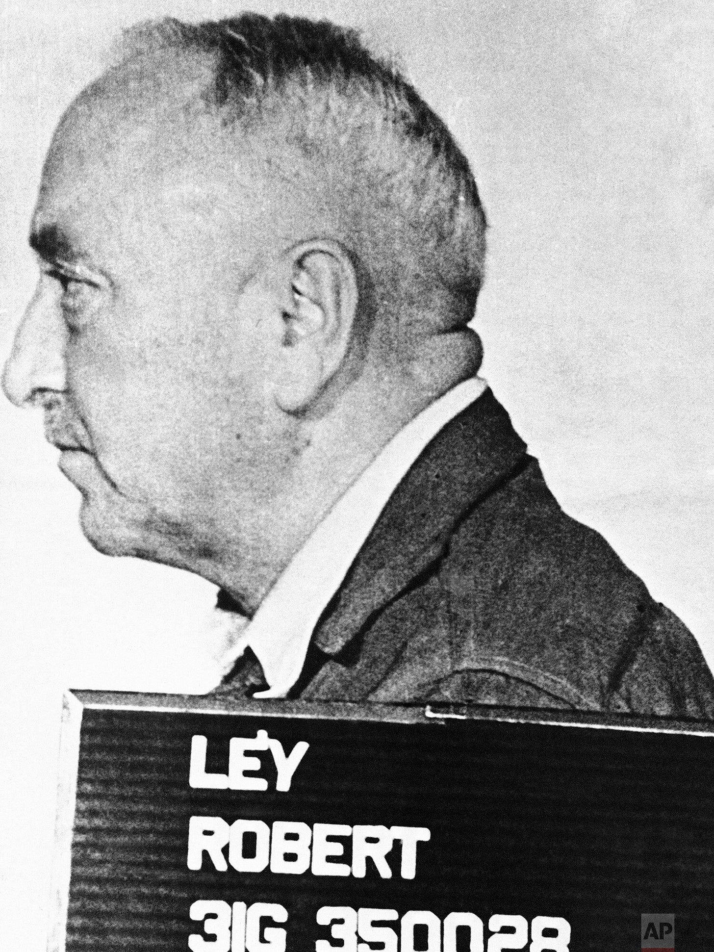 Official portrait of Dr. Robert Ley, Head of the German Labour Front, photographed November 5, 1945. Ley, a high-ranking Nazi official, committed suicide in his cell just weeks before the Nuremberg Trials began, escaping justice. Official portrait of Dr. Robert Ley, Head of the German Labour Front, photographed November 5, 1945. Ley, a high-ranking Nazi official, committed suicide in his cell just weeks before the Nuremberg Trials began, escaping justice.