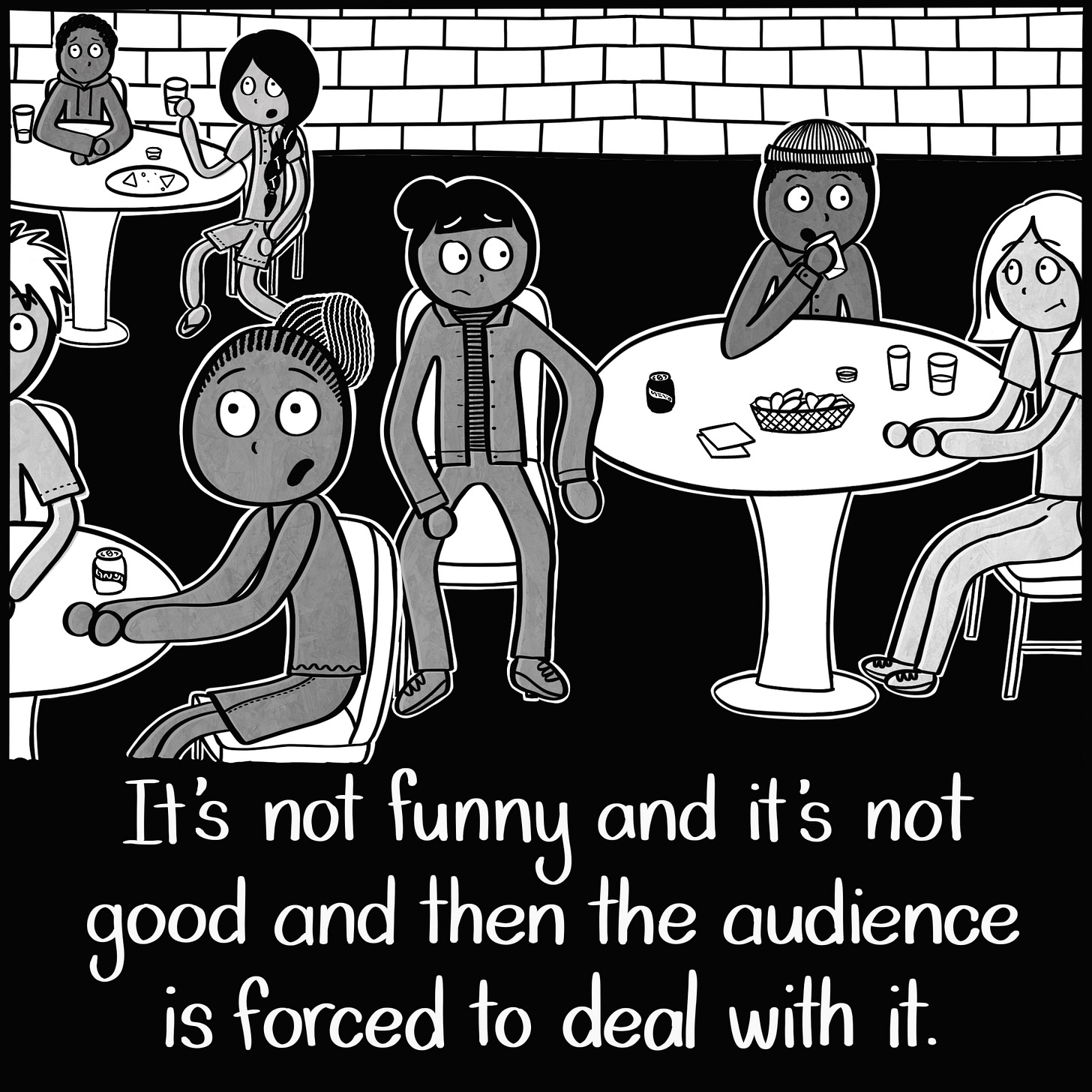 Caption: It's not funny and it's not good and then the audience is forced to deal with it. Image: A group of people sitting at tables with uncomfortable looks on their faces.