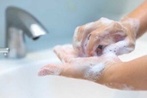 Person washing their hands.