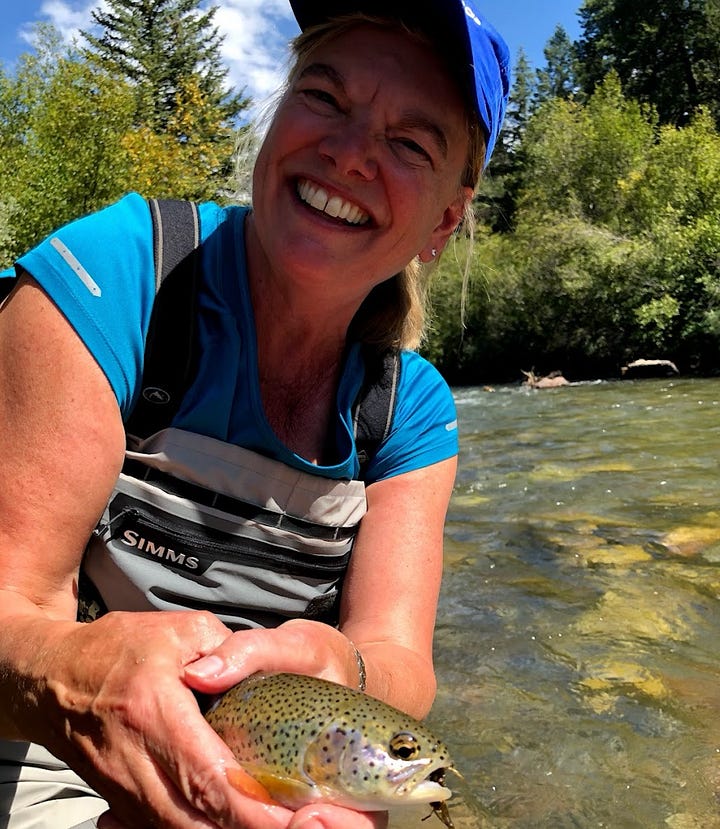 Top left: Melora Fern holding a trout smiling wearing a blue cap, Top right: Melora fern wearing a hiking hat smiling in front of a green coastline, Bottom left: Melora Fern smiling wearing a straw hat in front of a beach. Bottom right: Melora Fern smiling with her eyes closed wearing a blue beanie