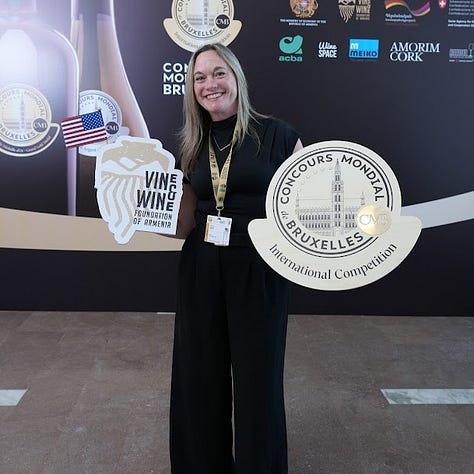 Kristy posing with Concours Mondial de Bruxelles signage across three years of judging: the 2026 Yerevan, Armenia session with the Vine & Wine Foundation of Armenia logo, the 2024 Guanajuato, Mexico session holding a U.S. flag, and the 2025 China session holding her certificate of participation amid rows of judging tables