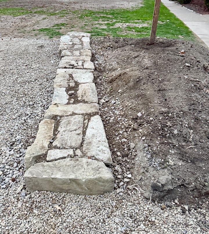 Two shorter recycled stone walls completed by James, the second in the dark with the street light! 