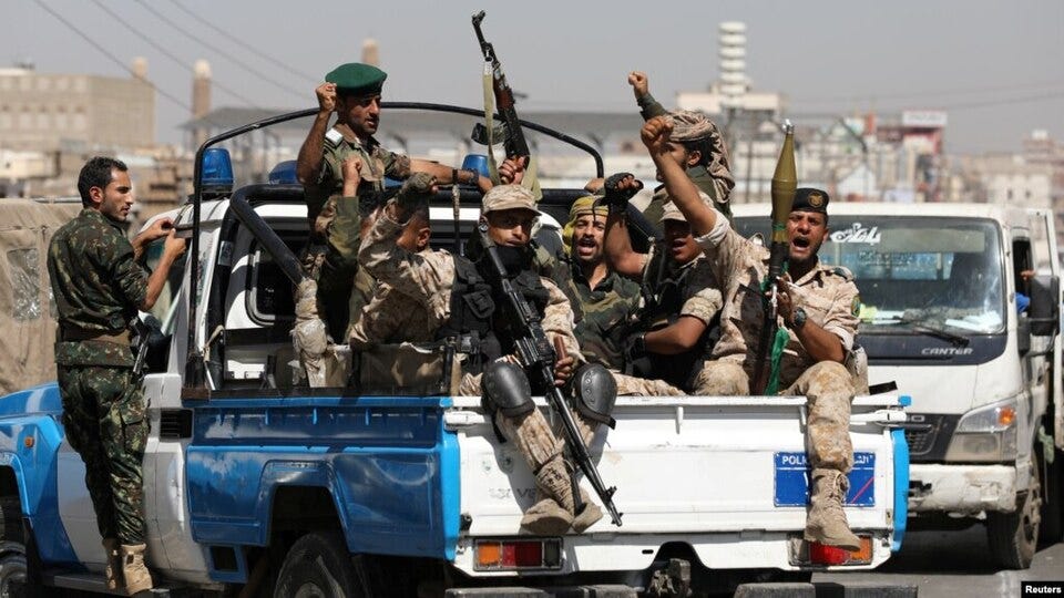 File:Yemeni Houthi troops ride on the back of a police patrol truck after participating in a Houthi gathering.jpg