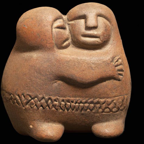 sculptures of people hugging